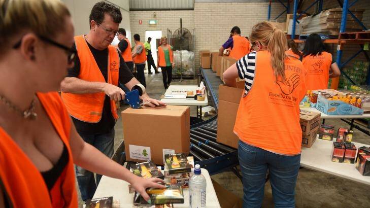 Volunteers pack hampers at Wetherill Park Foodbank. Photo: Nick Moir