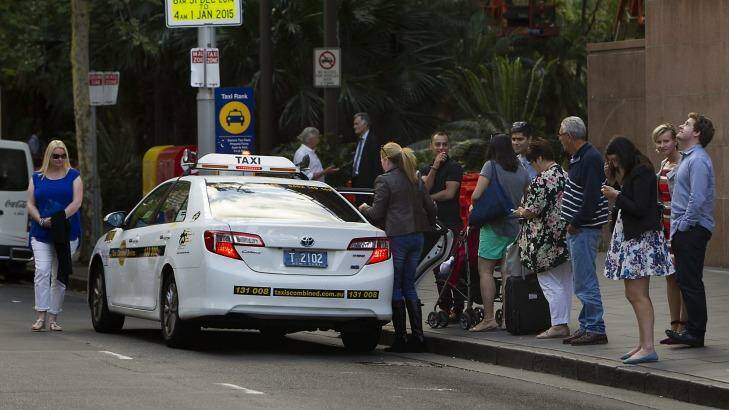 People queue for taxis at circular quay in Sydney. Photo: Sahlan Hayes