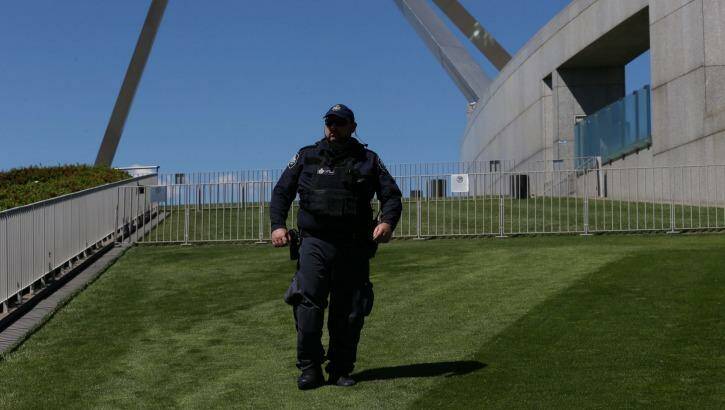 A security guard patrols the lawns at Parliament House. Photo: Andrew Meares