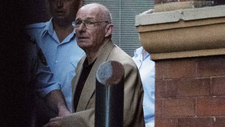  Roger Rogerson is led away from the Supreme Court on April 27. Photo: Christopher Pearce