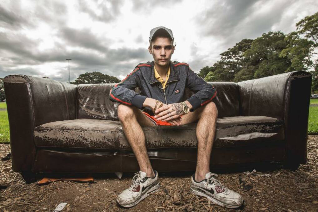 Jaike Digney has few photo opportunities and posed for his portrait on a discarded couch. Photo: Cole Bennetts