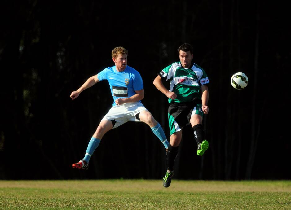 Hang time: Mitch Davis and Andy Collins jump for header in Port United's win over FC on Saturday.  
Pic: MATT McLENNAN