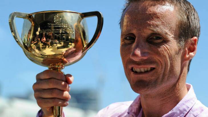 Flashback: Damien Oliver with the 2013 Melbourne Cup which he won on Fiorente. Photo: Sebastoan Costanzo
