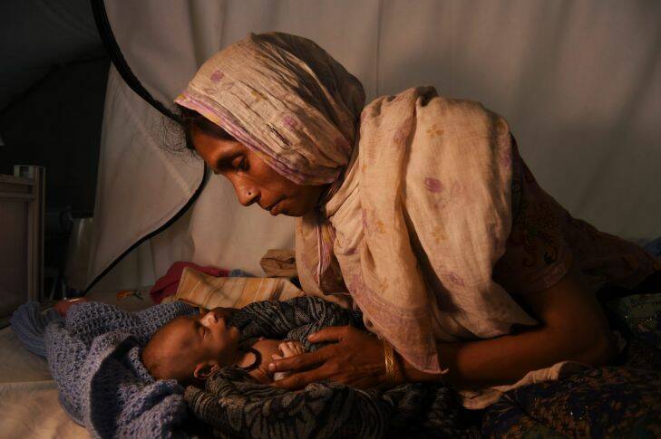 ROHINGYA INTERVIEW
Laila Begum holds her son Mohammed Ifran??????s hand as he recieves treatment at the Red Cross Field Hospital in Kutupalong refugee camp. Mohammed only 40 days old, is malnourished and weighed 1.8 kilograms. Kutupalong, Cox??????s Bazar, Bangladesh. 28th November, 2017. Photo: Kate Geraghty