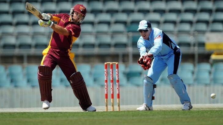 Chris Hartley plays a shot, watched on by Brad Haddin. Photo: Colleen Petch