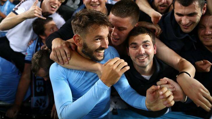 Happy days: Milos Ninkovic of Sydney FC celebrates with fans after the derby win against the Wanderers.
 Photo: Ryan Pierse