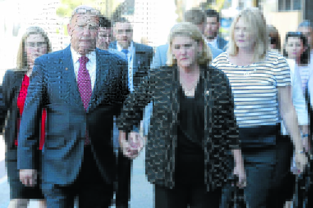 FINDINGS DELIVERED: Constable Bill Crews’ parents, Kel and Sharon Crews, arrive at the Coroner’s Court in Glebe on Monday. Photo: Peter Rae