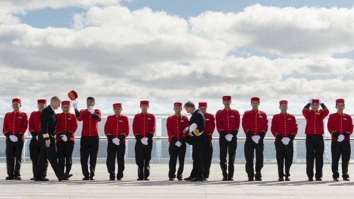 Bellboys line up for inspection on the Queen Mary 2.   Photo: James Morgan