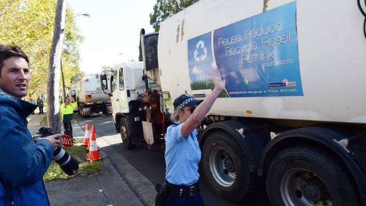 Police guide garbage trucks from Blacktown at the protest against SBS show <i>Struggle Street</i>. Photo: Nick Moir