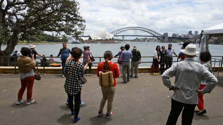 Tourists gather for the iconic Sydney photo at Mrs Macquaries Point. Photo: Dallas Kilponen