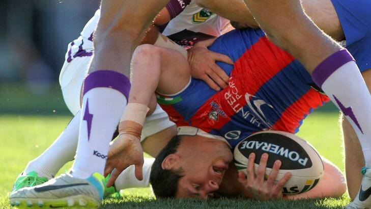James McManus of the Knights is tackled to the ground during the round in August, 2013 Photo: Tony Feder