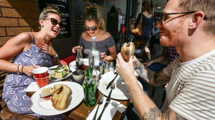 Hannah Campbell, Stephanie Hyde and 
David Wood enjoy a recovery breakfast at Coogee Cafe after a big night out. Photo: Dallas Kilponen
