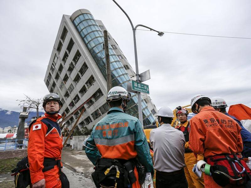 Seven people are believed trapped in a building that was tilted by the deadly quake in Taiwan.