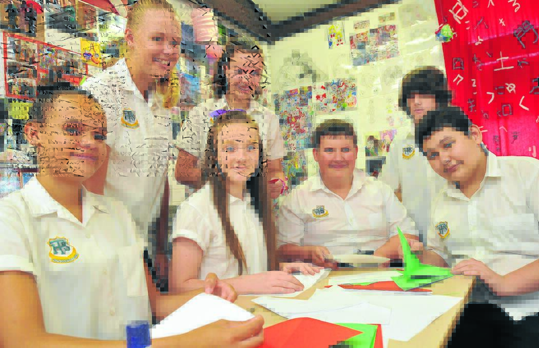 IN	THE	FOLD: Peel High students, front from left, Barbara Jerrard, Tara McIntosh, James Kellner and Jade Clare, and back, Ashley Maunder, Lauren McGill and Bailey O Donohue learn the finer points of one of Japan s most famous artistic pursuits, origami. Photo: Geoff O Neill 081214GOA01