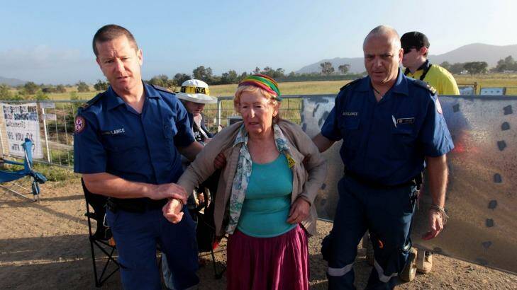 Paramedics assist a woman at the protest site.  Photo: Dean Sewell