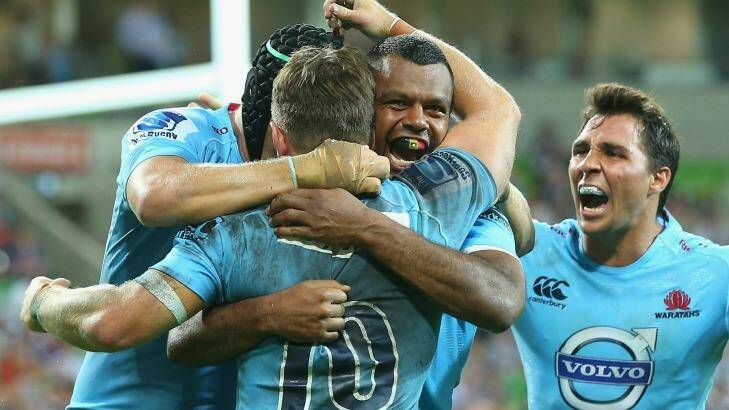 Kurtley Beale is congratulated by Waratahs teammates after scoring against the Rebels at AAMI Park on Friday. Photo: Quinn Rooney