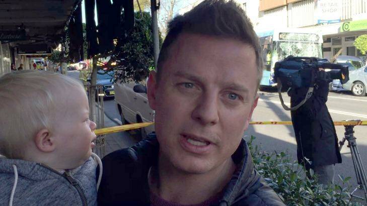 Ben Fordham, holding his son Freddy, helped the bus driver in the Cammeray crash. Photo: Peter Munro