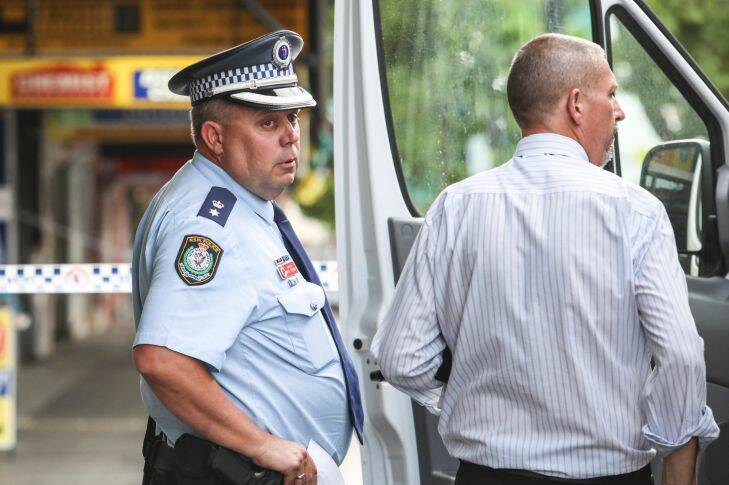 Inspector Brad Thorne looks on as Police work a crime zone after a reported shooting in Bankstown CBD in front of a cafe, 23 January 2018. Photo by Cole Bennetts