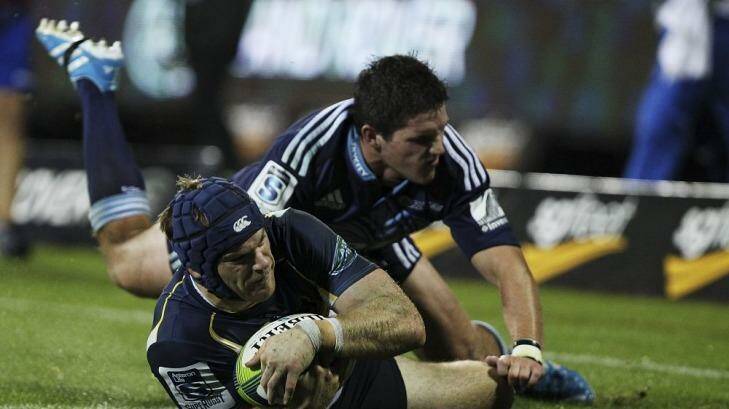 Pat McCabe scores one of his two tries against the Blues on Friday night,