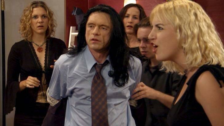 Tommy Wiseau (centre) in a still from his film The Room. 