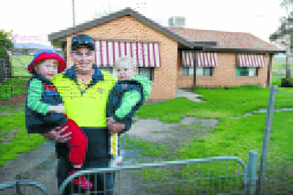 TEAM	EFFORT: Tamworth father Cameron Adams, with sons Caleb, 3, and Charlie, 1, outside the home bought through the compassionate heart of the community. Mr Adams, who lost his wife to cancer in June, says he is overwhelmed by the gesture. Photo: Barry Smith 290814BSG03