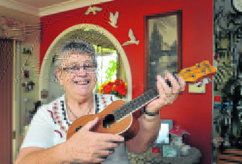 STRUMMING THE HEART STRINGS: Margaret Bosworth is taking up the ukulele in memory of her late husband, Peter. She is just one of many locals – young and old – picking up the increasingly popular instrument. Photo: Geoff O’Neill 020115GOA01