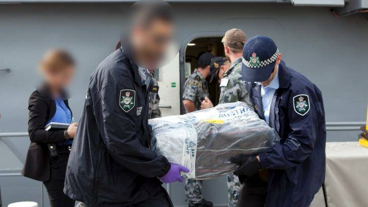 Australian Federal Police officers carry bags of cocaine. Photo: Australian Federal Police.