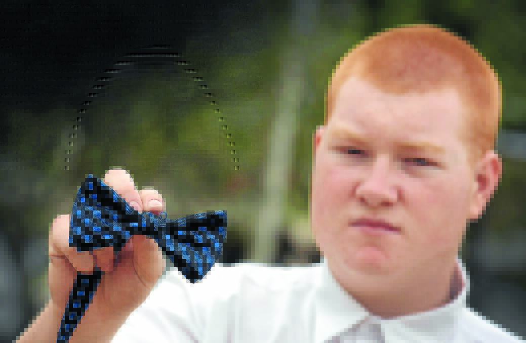HANDS TIED: Oxley High student Dylan Sollars with the bow tie at the centre of a uniform controversy. Photo: Gareth Gardner