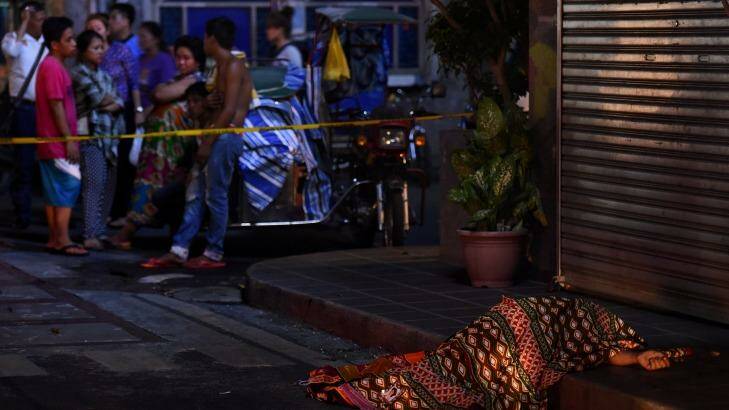 One of two people killed in a double shooting in the Manila suburb of Baclaran is left lying in the street.  Photo: Kate Geraghty