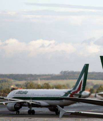 Logos sit on the tailfins of aircraft operated by Alitalia SpA, at Fiumicino airport in Rome, Italy, on Wednesday, Feb. 12, 2014. Etihad Airways PJSC said it will decide within 30 days whether to buy a stake in ailing Italian airline Alitalia SpA as the Abu Dhabi flag carrier continues its streak of purchases to funnel traffic through the Middle East. Photographer: Alessia Pierdomenico/Bloomberg Photo: Alessia Pierdomenico