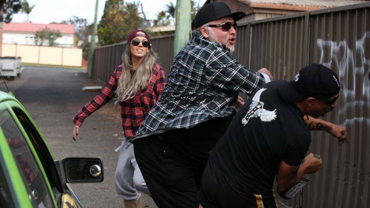 Kyle Sandilands swings into a new career in Fat Pizza vs Housos. Photo: Supplied