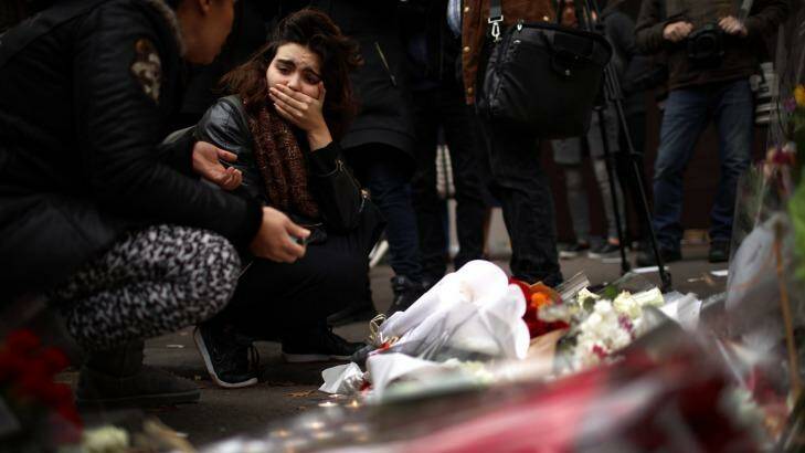 A woman places flowers near the scene of the Bataclan Theatre terrorist attack. Photo: Christopher Furlong, Getty Images