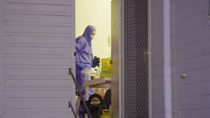 Police conduct a forensic examination of the premises. Photo: Frank Red