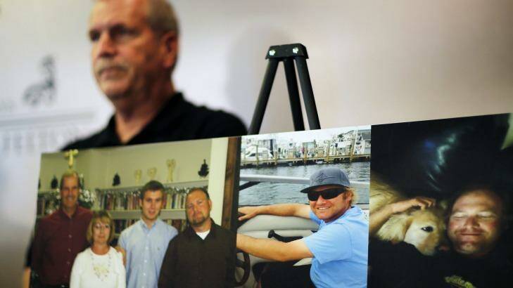 Photos of Chase Sherman are displayed as his father Kevin Sherman attends a news conference. Photo: AP/David Goldman