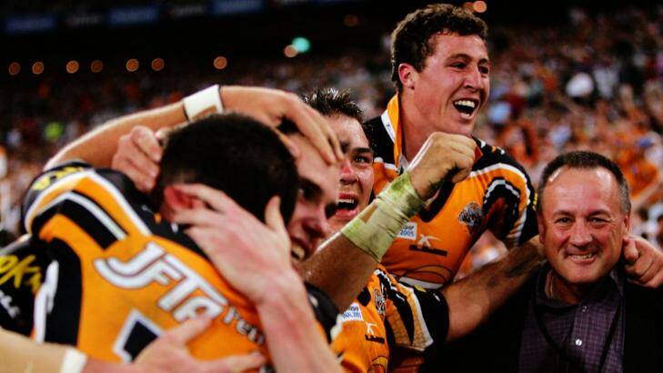 Tim Sheens celebrates the Tigers' 2005 premiership with the players. Photo: Craig Golding
