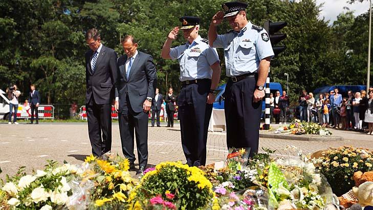 Remember them: Tony Abbott with special envoy Angus Houston, defence chief Mark Binskin and AFP commissioner Tony Negus with tributes to the MH17 victims. Photo: Kate Geraghty