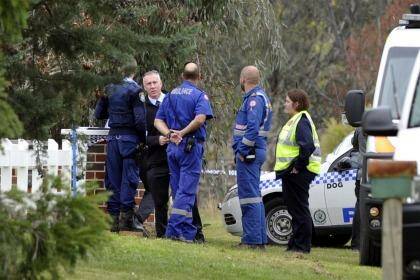 Police and ambulance officers outside the Springvale Drive house of the deceased 83-year-old man.