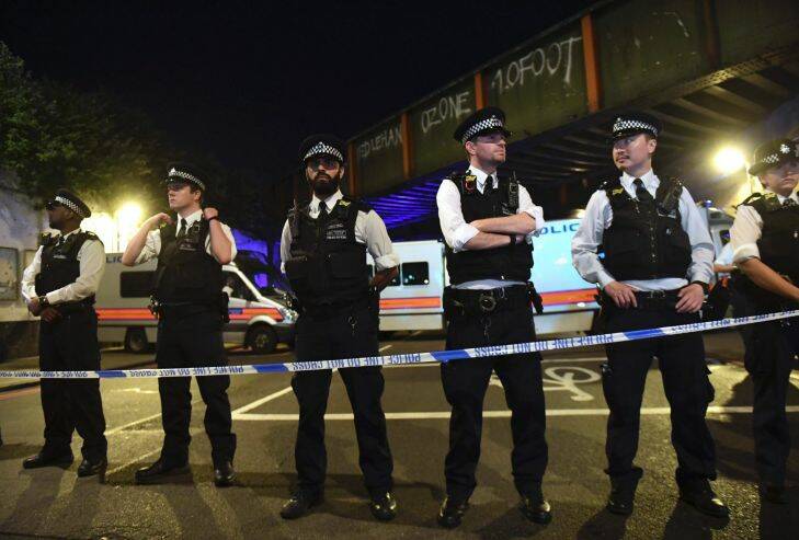 Police officers man a cordon near the Seven Sisters Road at Finsbury Park where a vehicle struck pedestrians in London Monday, June 19, 2017. Police say a vehicle struck pedestrians on a road in north London, leaving several casualties and one person has been arrested. (Yui Mok/PA via AP)