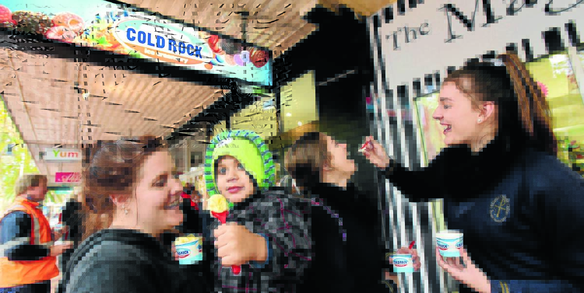 ROCKS IN THEIR HEAD: Jess Orcher, Hunter Orche, 3, Sophie Pennell, 15, and Izzy Ambrose, 16, brave the freezing conditions to sample the delights on offer at Cold Rock Ice Creamery, which opened in Peel St yesterday. Photo: Gareth Gardner 140715GG03