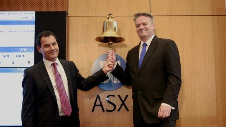 Medibank chief George Savvides and Finance Minister Mathias Cormann ring the bell to send Medibank Private live. Photo: ASX