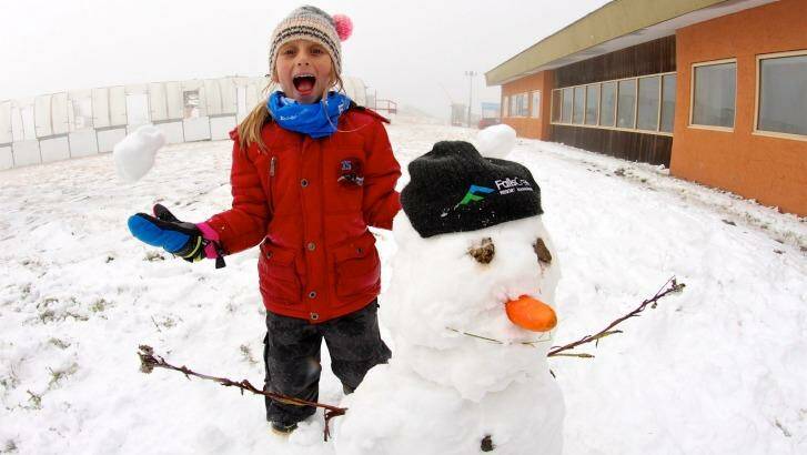 Jacinta Jansen, aged seven, with her first snowman for the year at Falls Creek. Photo: Chris Hocking