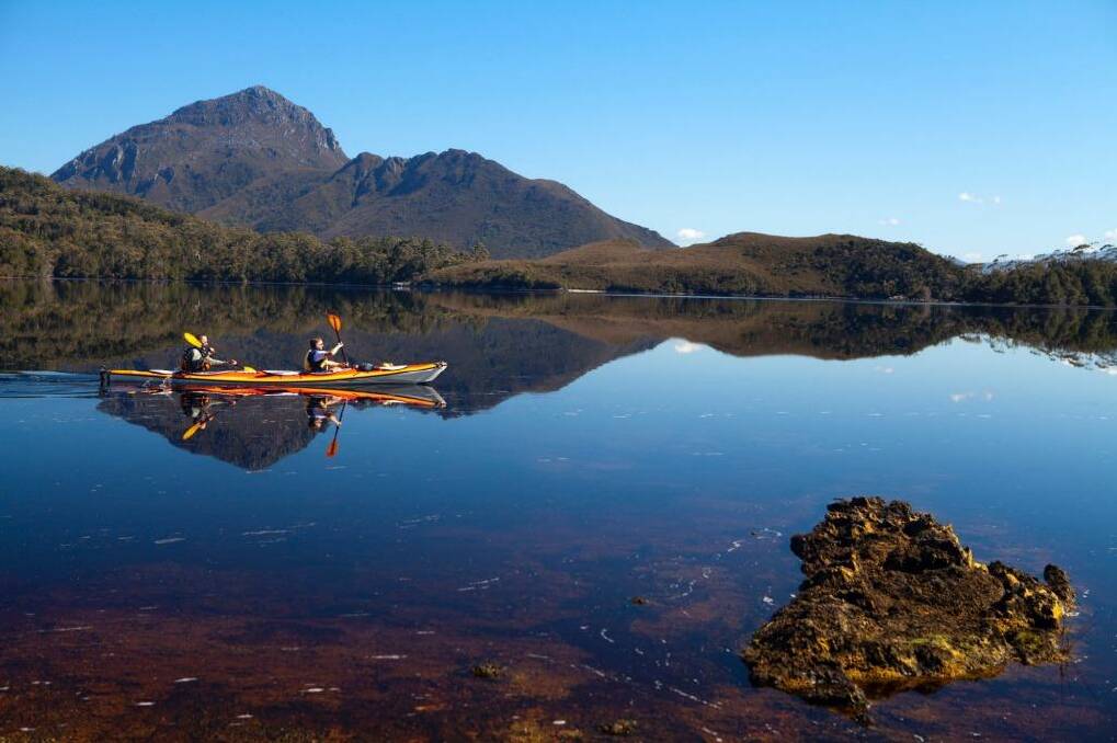 Paddling through Forest Lagoon at the edge of Bathurst Harbour, with Mount Rugby behind. Photo: Andrew Bain