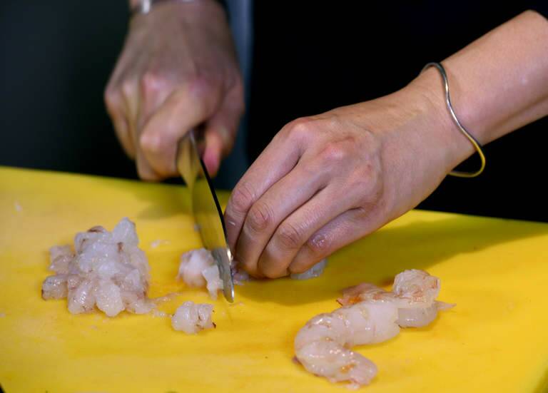 Peel and devein prawns and dice the prawn meat.