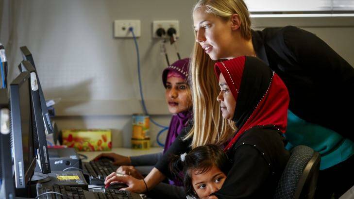 Zoe Seeberg-Gordon (centre) from the Australian Multicultural Foundation teaching IT skills to recent migrants so they can better understand what kids are looking at online. Photo: Eddie Jim