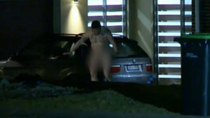 A naked man emerges from the home in Luddenham after a home invasion. Photo: Nine News