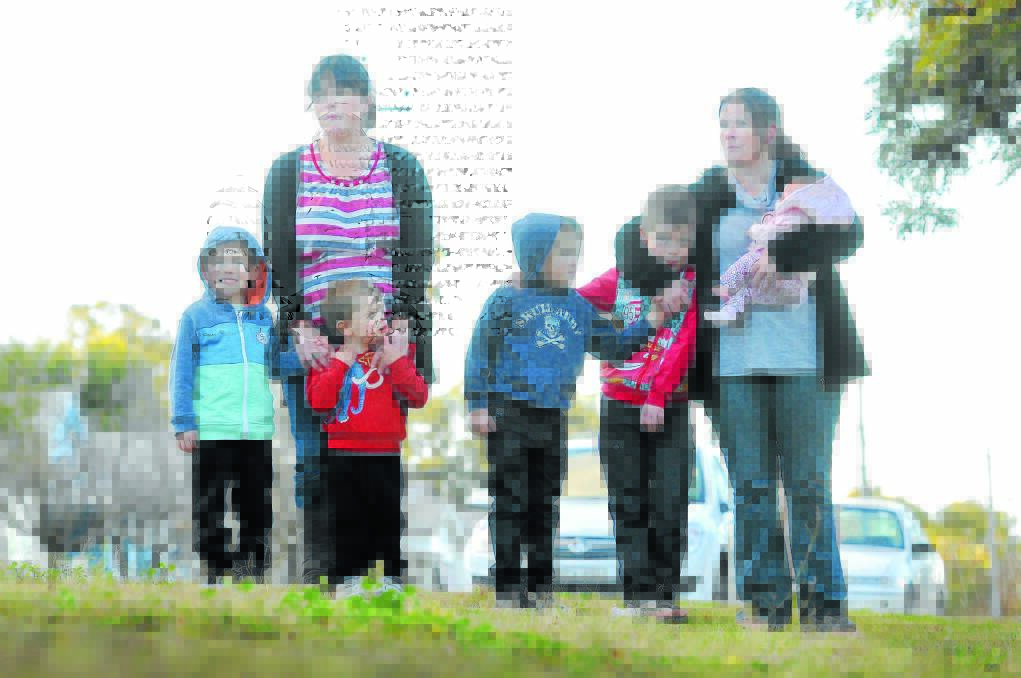 HOLD THEM CLOSE: Local sisters Kristy Heywood and Leeanne Patton, with kids, from left, Logan Heywood, Kobi Heywood, Chase Patton, Adam Patton and Hannah Heywood, are urging parents to sign a petition for a national sex offenders register. Photo: Gareth Gardner 180714GGE01