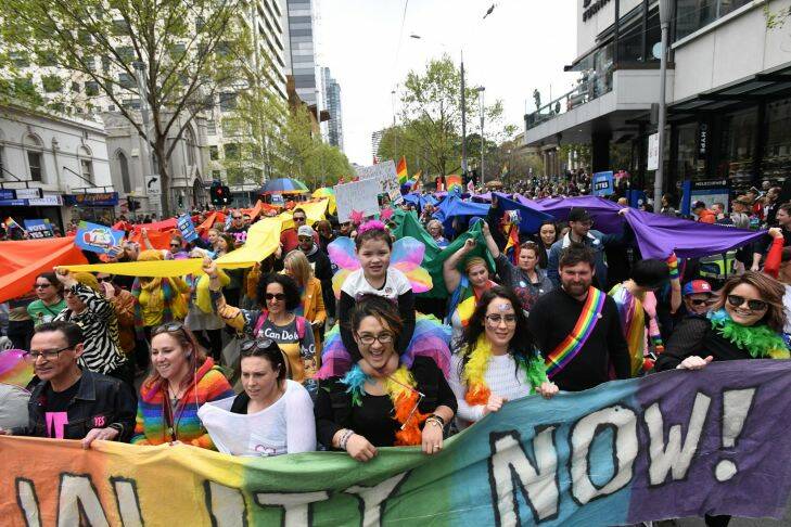 Same Sex marriage demonstrators are seen parading along Swanston street in Melbourne on Sunday, October, 1, 2017. The same sex marriage campaign seeks to push for a yes vote in the postal survey which is now open to the Public of Australia. (AAP Image/James Ross) NO ARCHIVING
