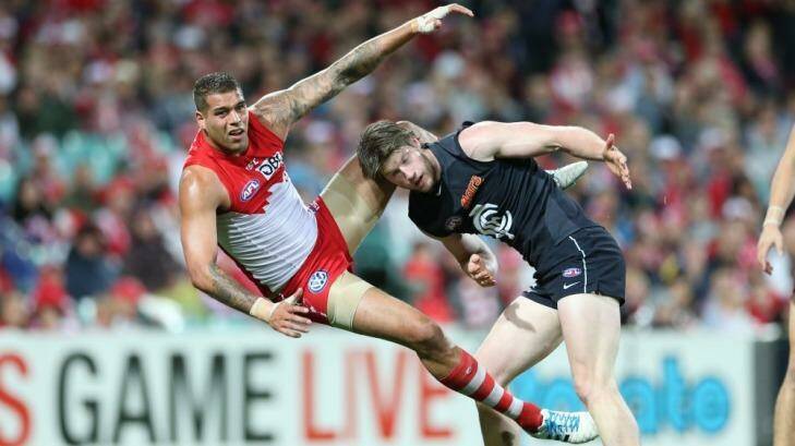 Oops: Sydney forward Lance Franklin gets tangled with Carlton's Sam Rowe. Photo: Anthony Johnson