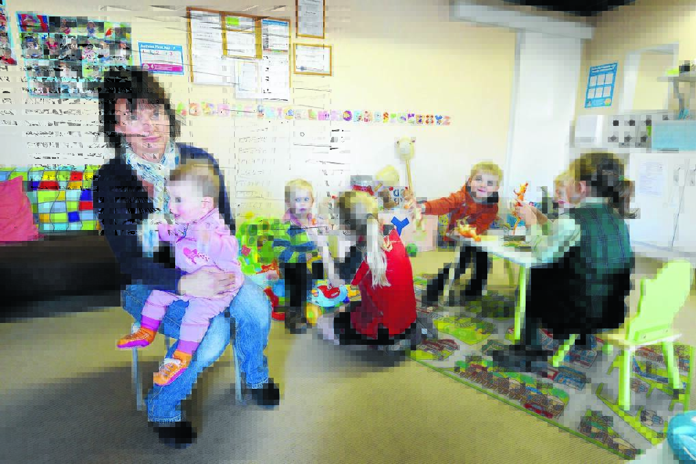 CASH CONCERN: Tamworth Family Day Care educator Tracey Wright is one of 76 educators with the service waiting to learn if it will be savaged by federal government cuts. She is pictured with baby Molly Sheridan, Oscar McMurtrie, Eliza Hodgson, Kaelan and Liam Moss and Thea Sheridan. Photo: Barry Smith 230714BSC05