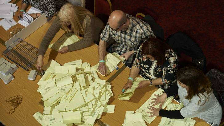 Counting staff sort ballot papers at a vote counting centre in Margate, southeast England, on May 7, 2015 during the UK general election.  Photo: Niklas Hallen 